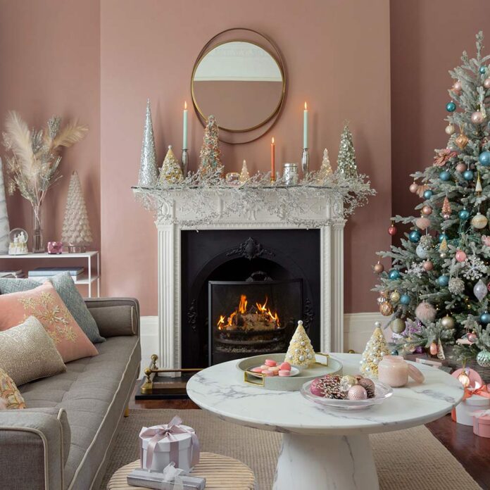 Pink living room with Christmas tree and pastel decorations