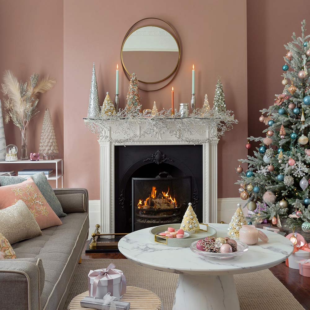 Pink living room with Christmas tree and pastel decorations