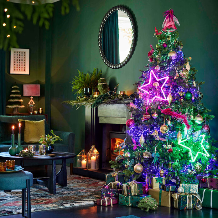 Neon lit up Christmas tree in green room