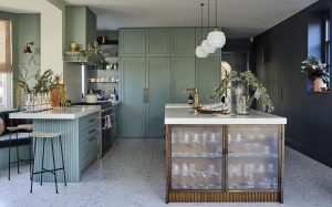 Painted contemporary kitchen with fluted glass cabinets.