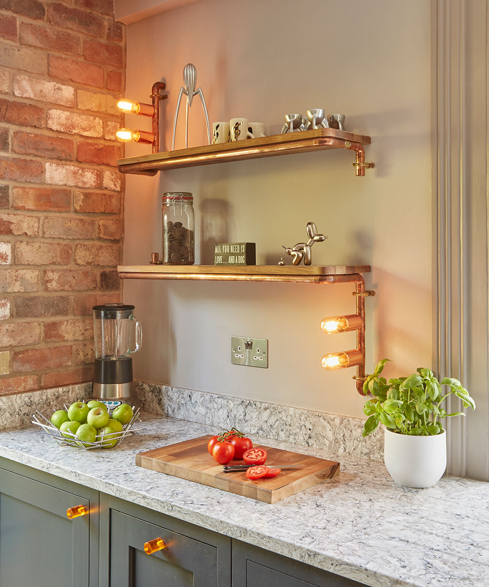 Industrial style kitchen with bare brick wall and open wall shelves made of wood