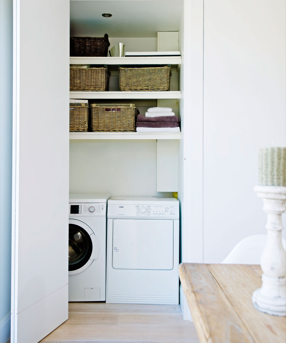 Washing machines built into cupboards in utility room