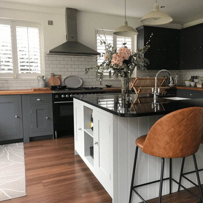 dark grey kitchen with island and tan bar stool