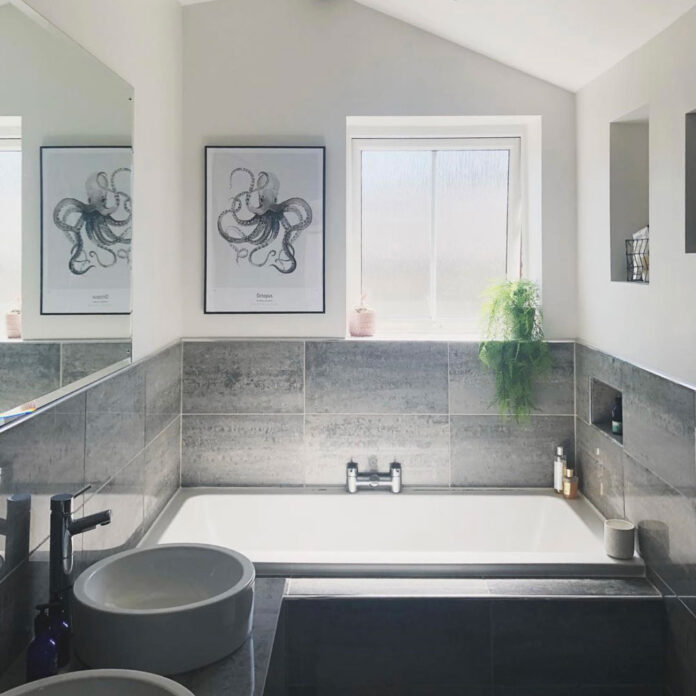 Grey tiled bath in small bathroom before makeover