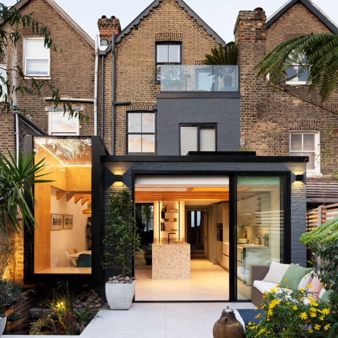 view of the exterior of a renovated victorian property with a glass extension