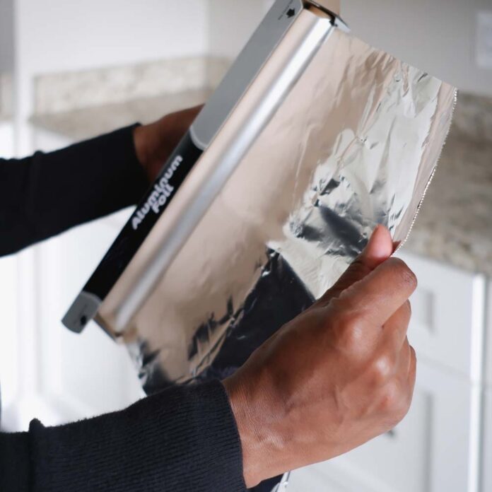 tin foil being used in the kitchen