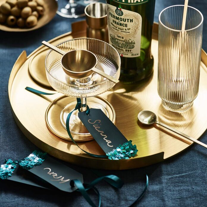 Gold tray on dining table with personalised labels