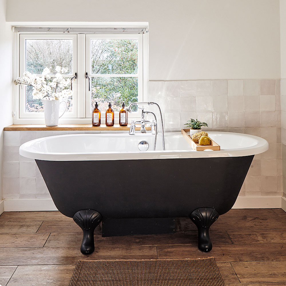 white cottage bathroom with roll top bath