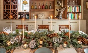 Christmas table with fir and pine cone wreath and candles