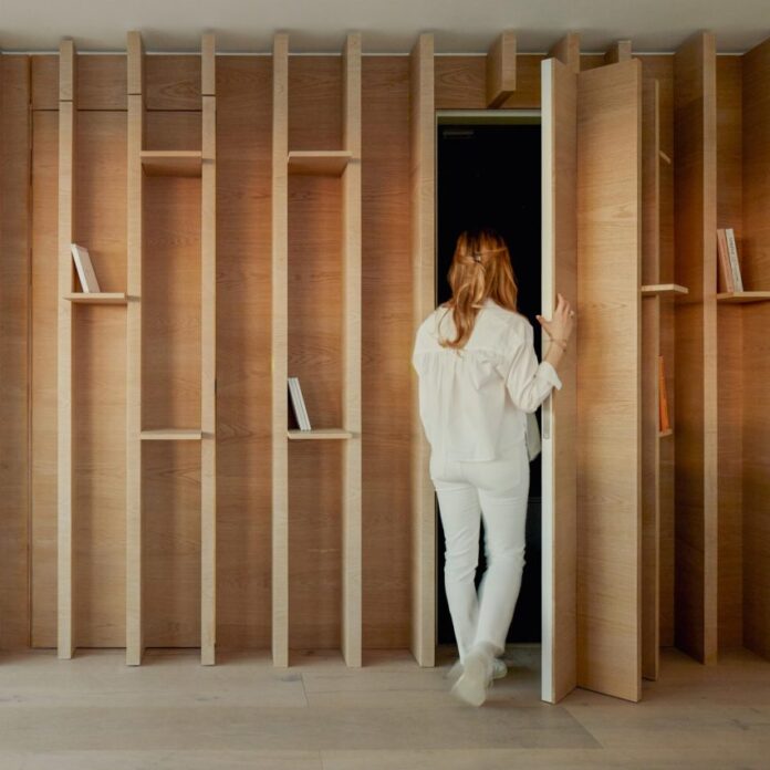 Joinery with hidden door in City Approach apartments by DROO