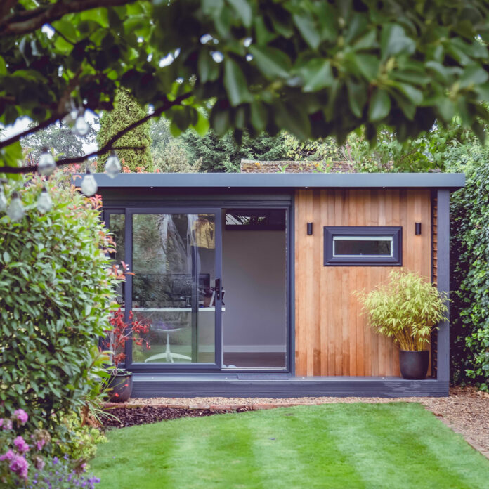 garden room with desk and chair at end of garden