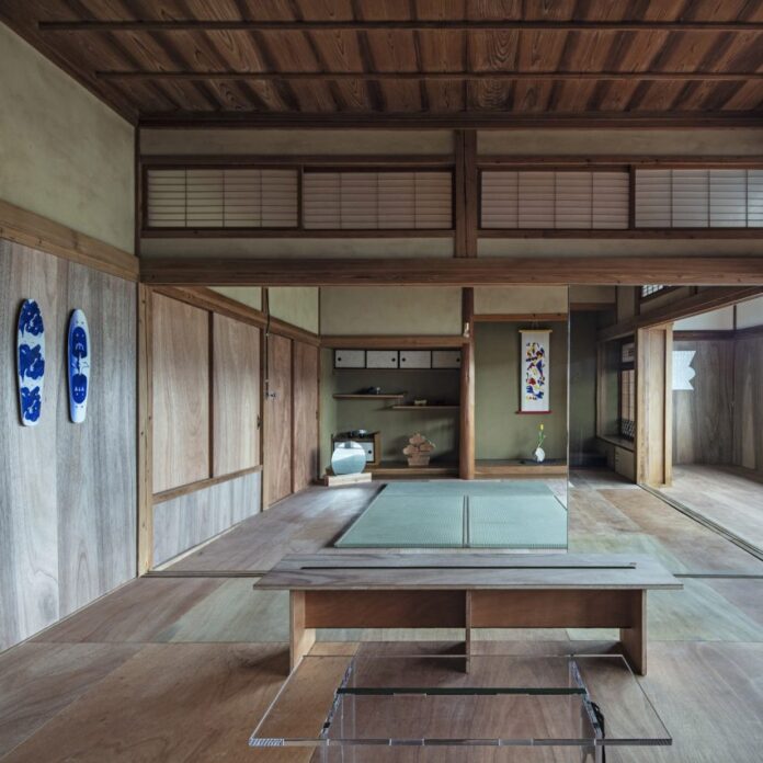 Artists workshop with wooden flooring in traditional Japanese house converted into office by DDAA Inc