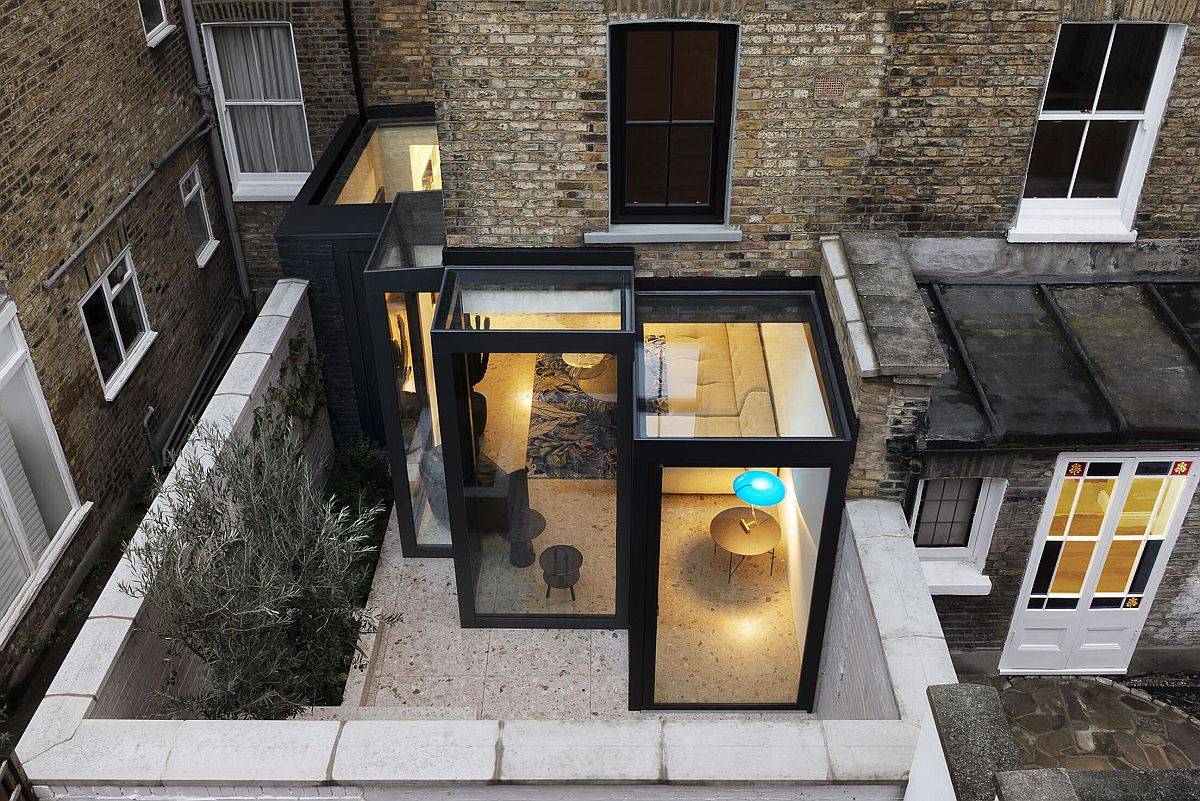 Custom box-style glass cabins extend the traditional London home