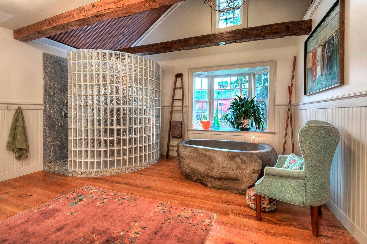 Exceptional bathroom with modern-rustic style, stone bathtub and a shower area with glass brick wall