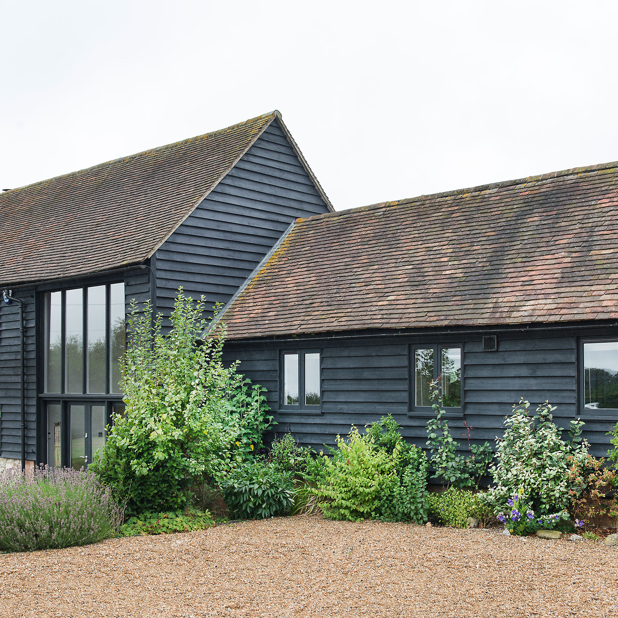 Dark grey barn conversion with naturalistic border