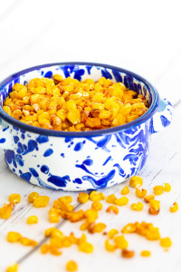 roasted corn in a blue and white ramekin make a healthy snack for dieters.