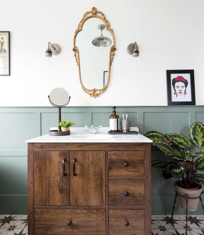 bathroom with green painted panelling and wooden sink vanity unit