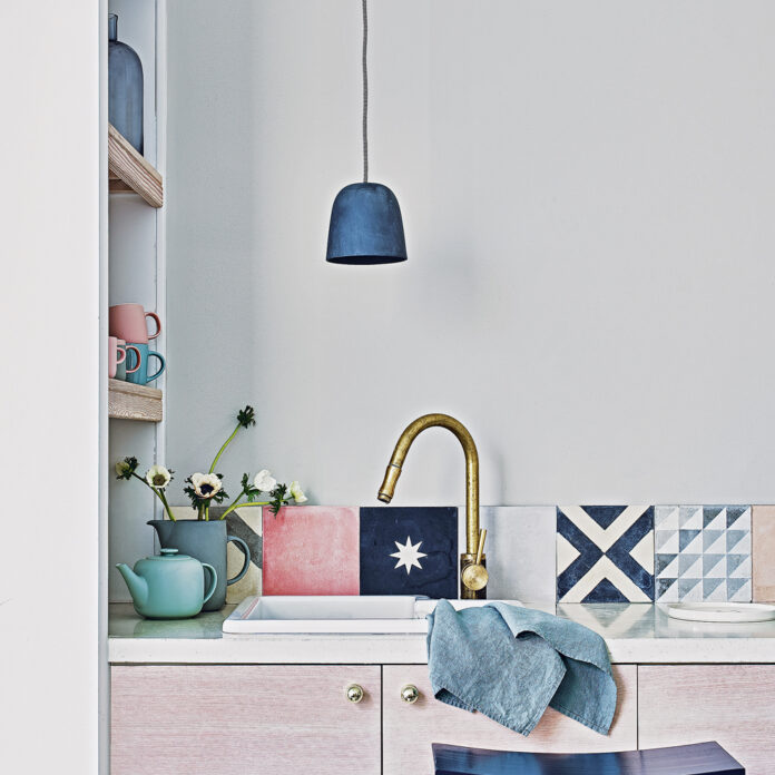 White kitchen with single tiled splashback in colourful tiles