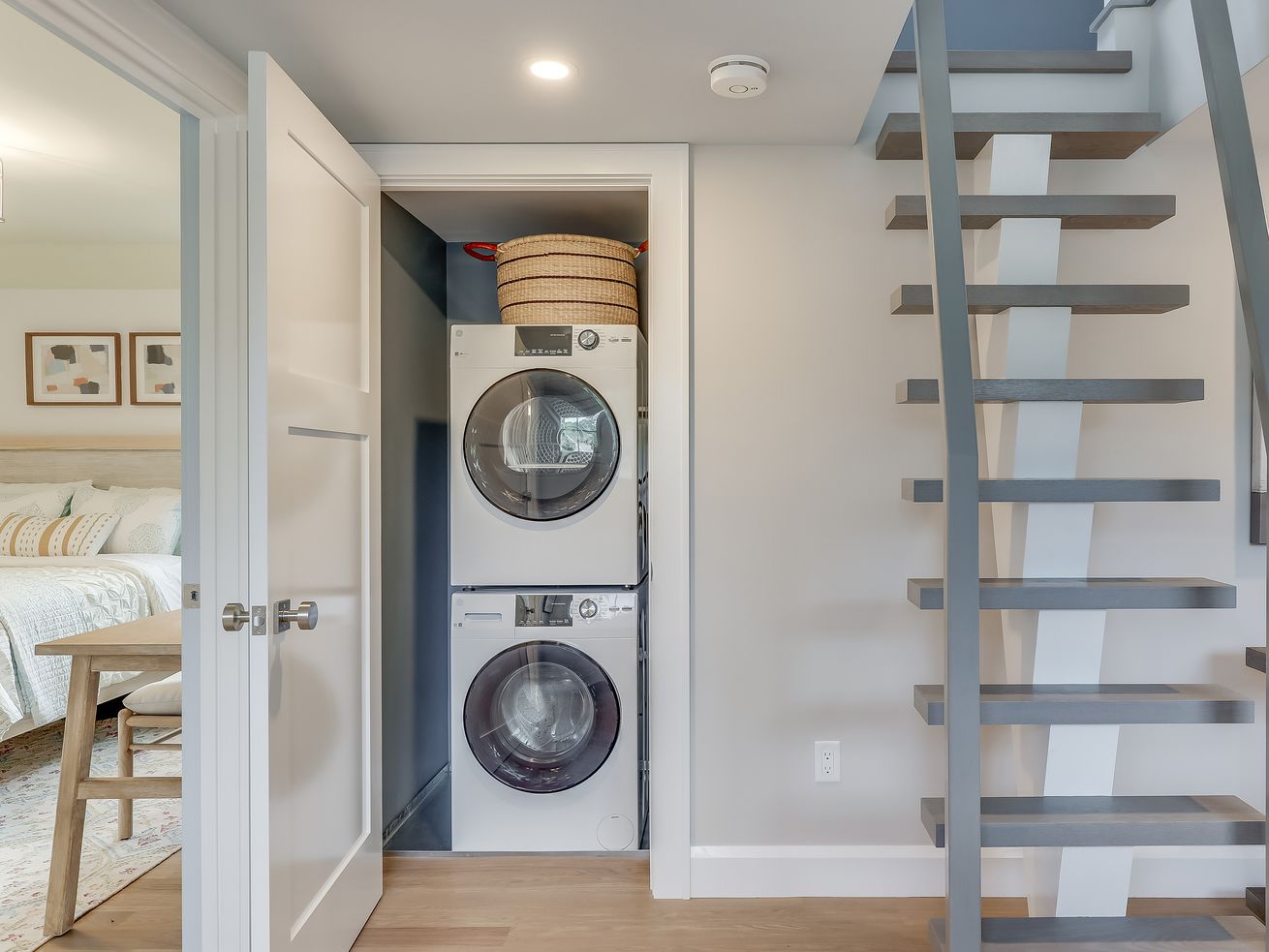 A stacked washer dryer in a closet.