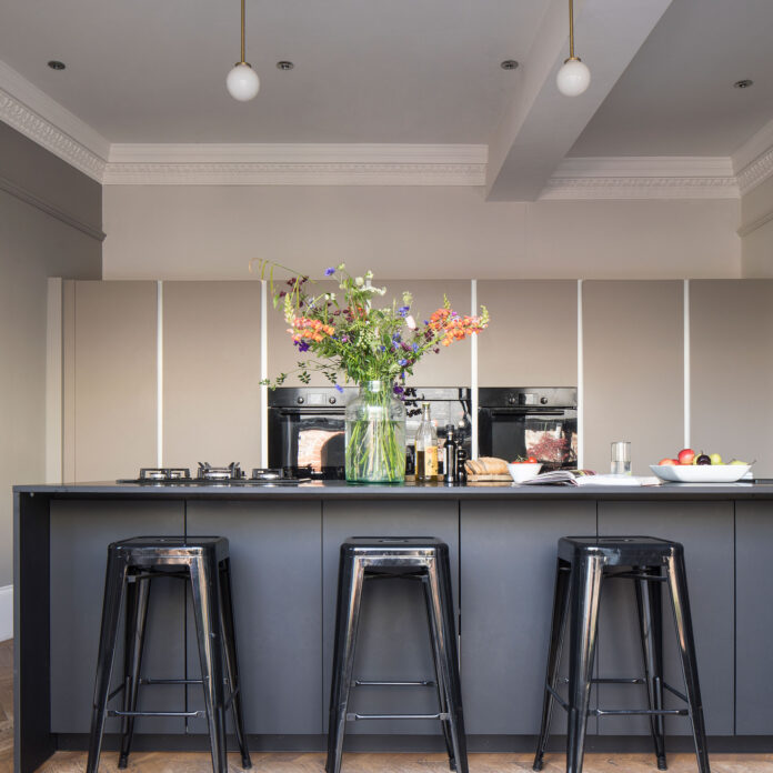 Kitchen with dark island and metal bar stools