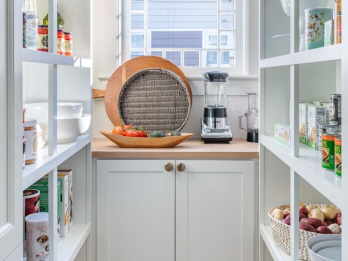 A clean pantry with with shelves. 