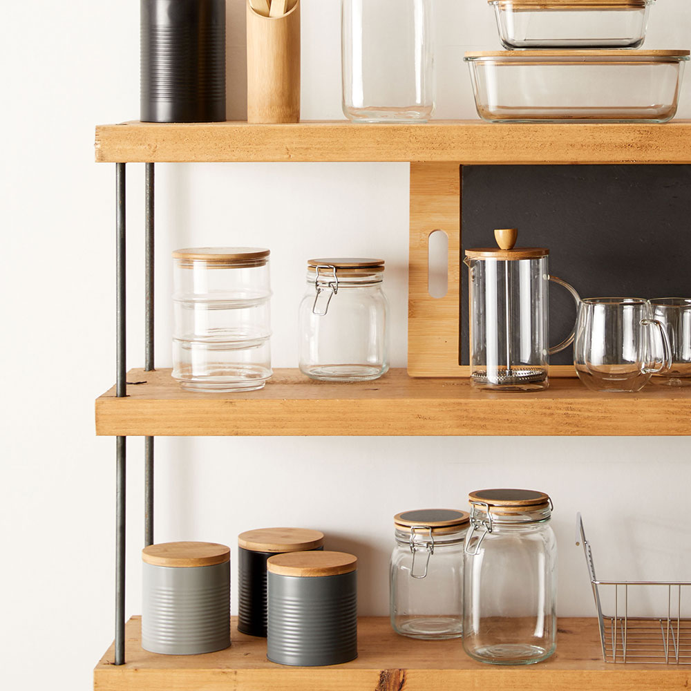 open wooden shelving with storage caddies
