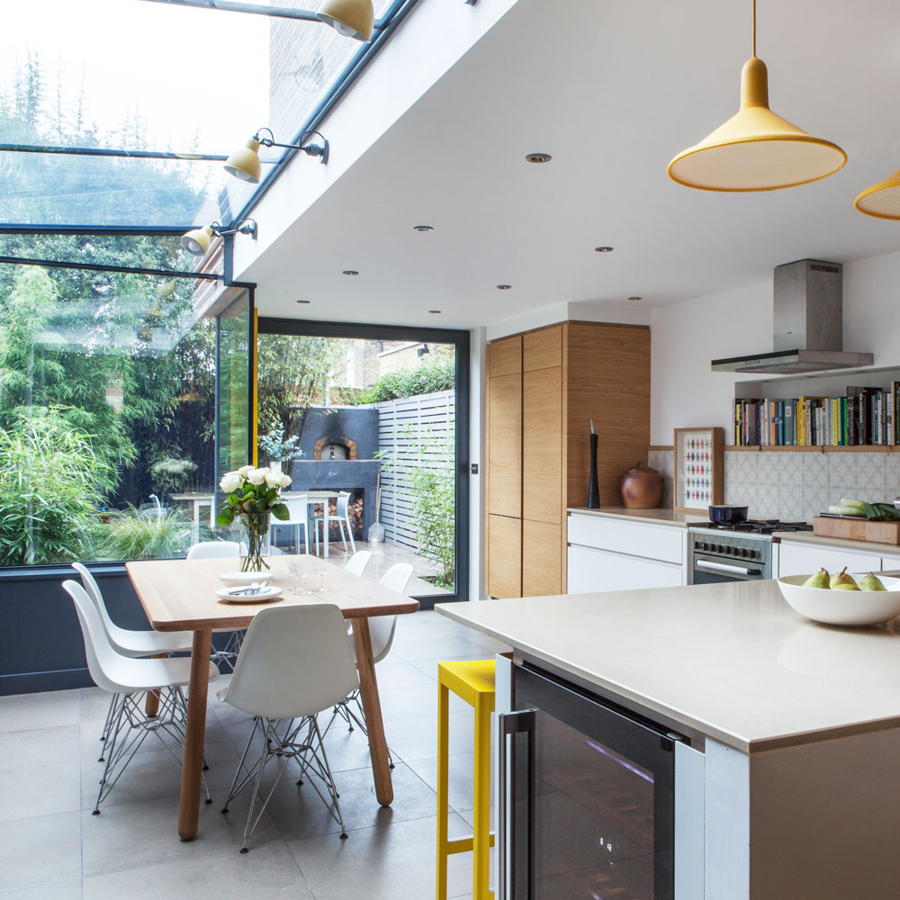 A kitchen extension with large windows looking out onto a garden