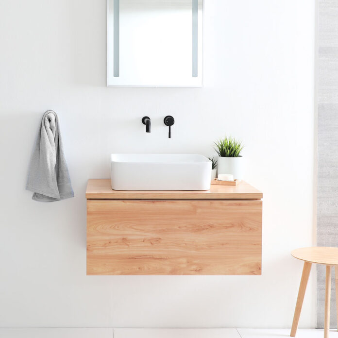 white sink on wooden stand in white minimalist bathroom