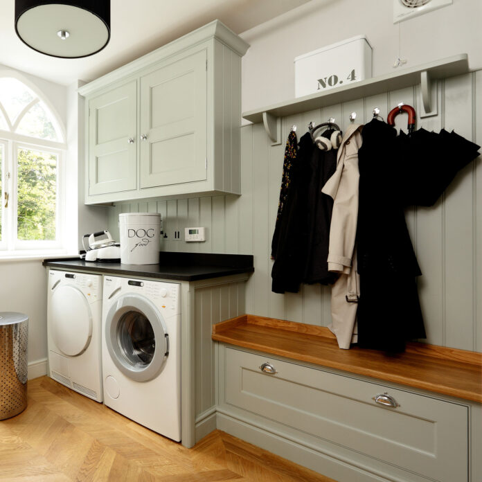 Utility room with washing machine and storage bench