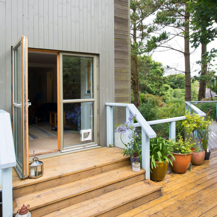 Exterior of house with wooden decking and steps