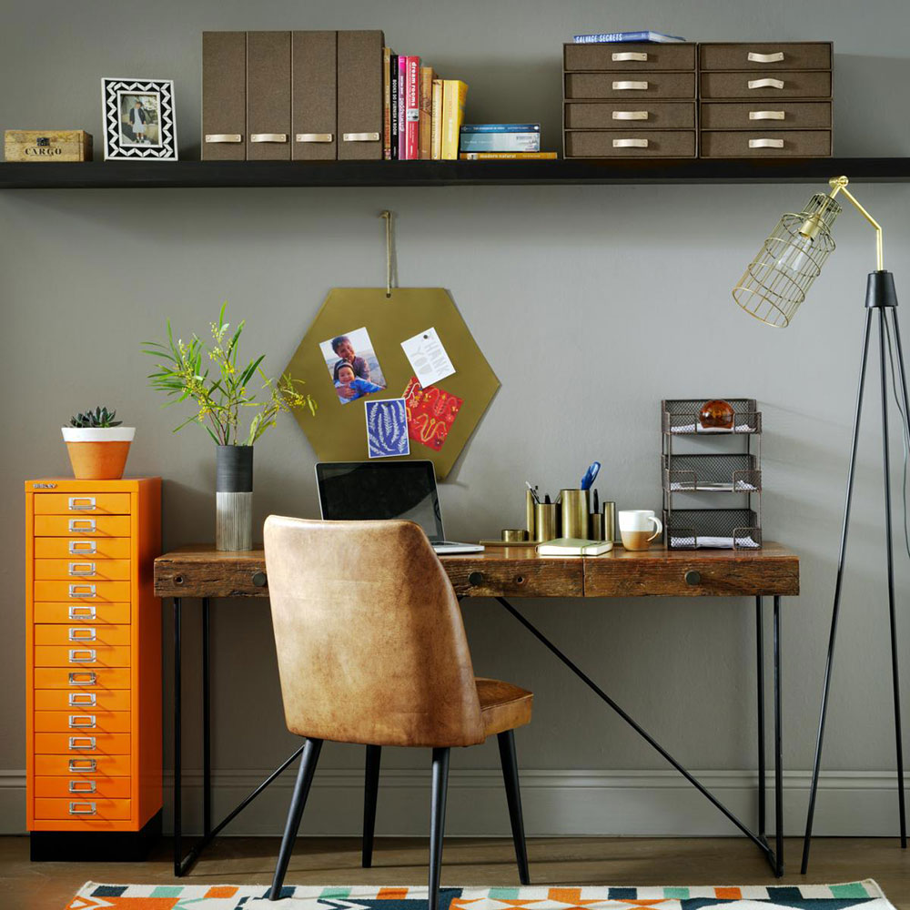 grey home office with industrial furniture, geometric rug and orange filing cabinet