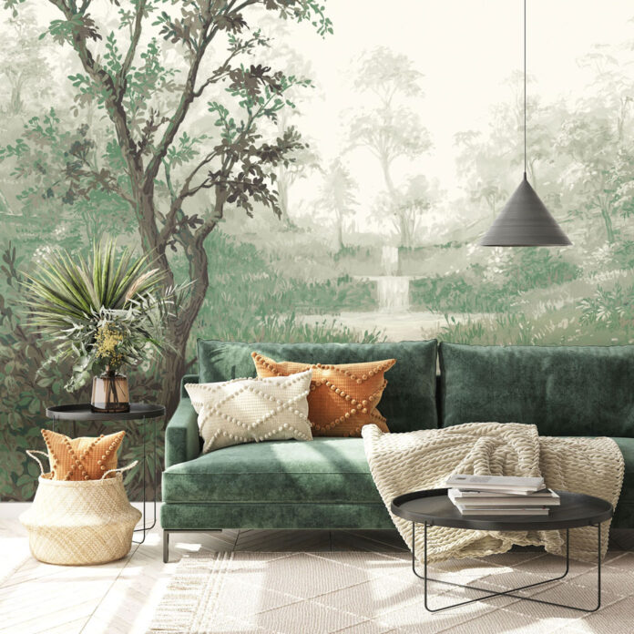 a green sofa in front of an oversized nature-themed mural with trees and plants