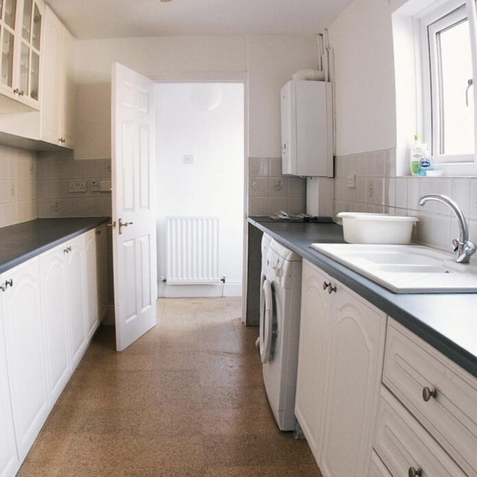 See how a drab cream kitchen was transformed by painting the cabinets black