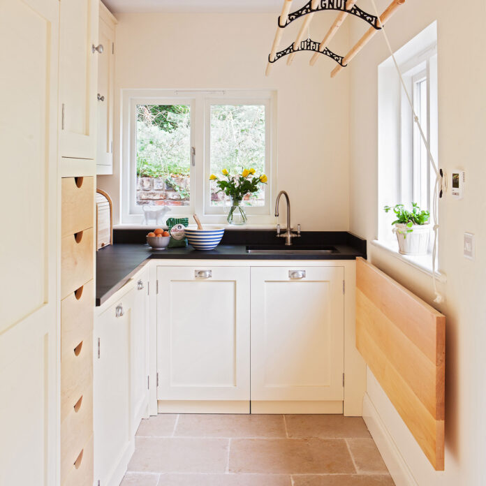 Pale pink utility room with laundry pulley 