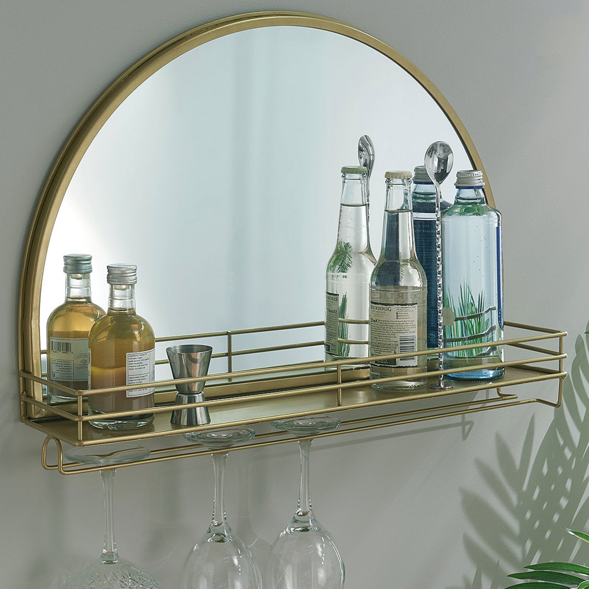 gold bar shelf with semi-circular mirror