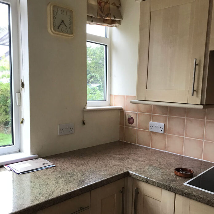 beige kitchen before a budget makeover with green paint