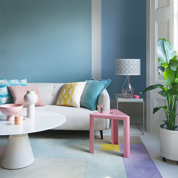 pale green and blue striped walls in livig room with white wofa