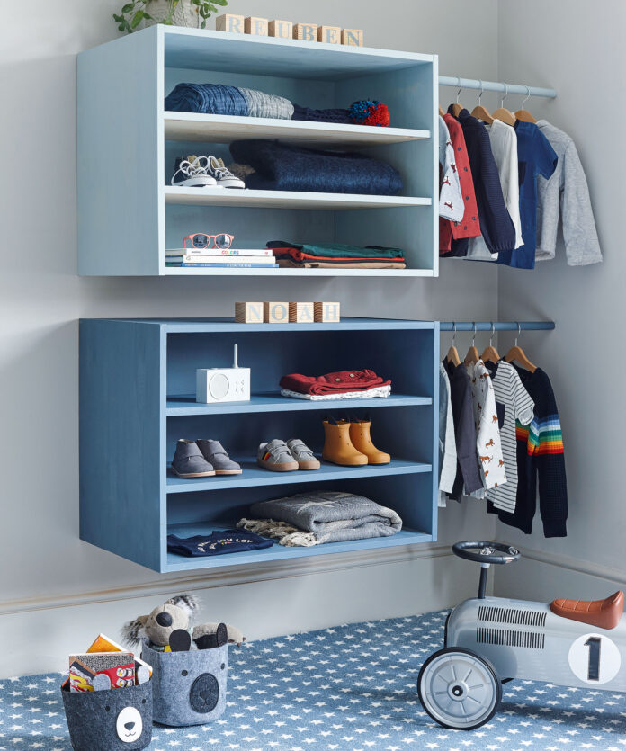 Open shelving on wall of kids bedroom with star carpet