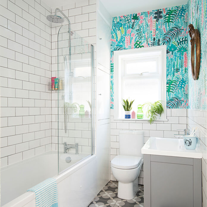 white tiled bathroom with turquoise floral wallpaper