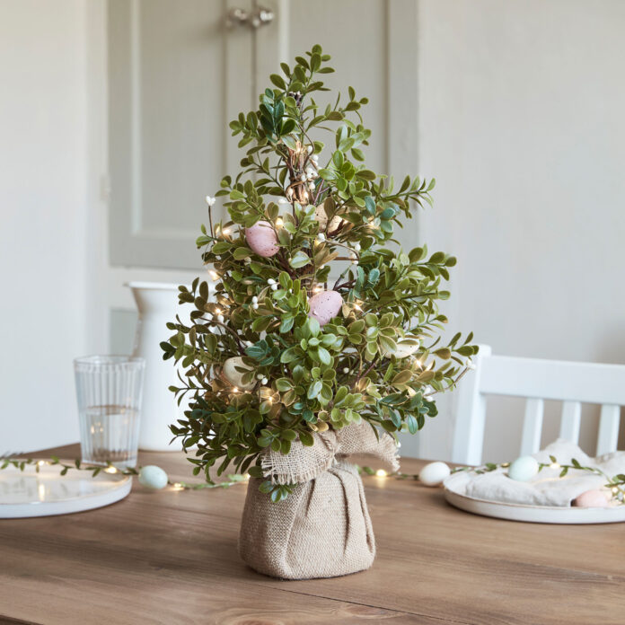 easter christmas tree on table with lights and egg shaped decorations