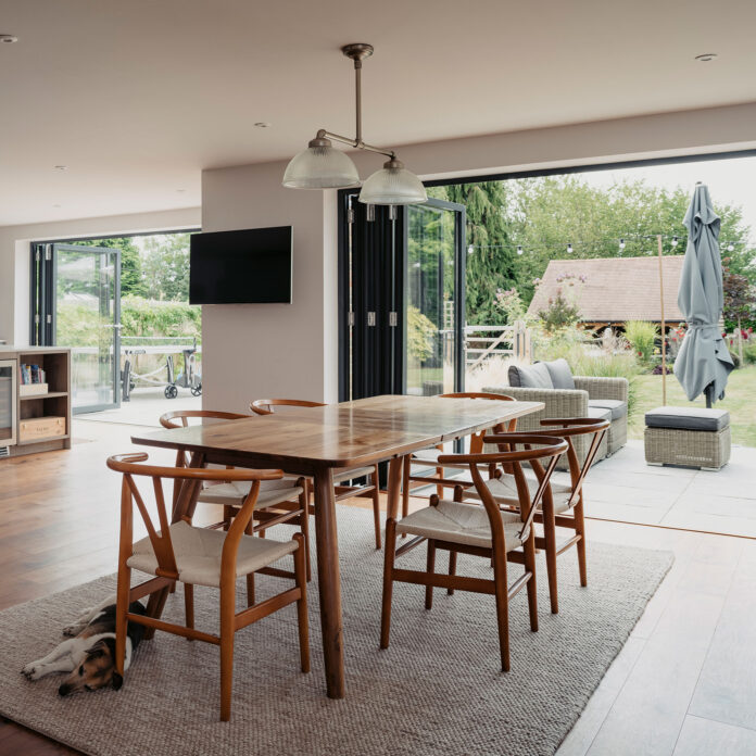 Open plan kitchen living room with open bifolding doors