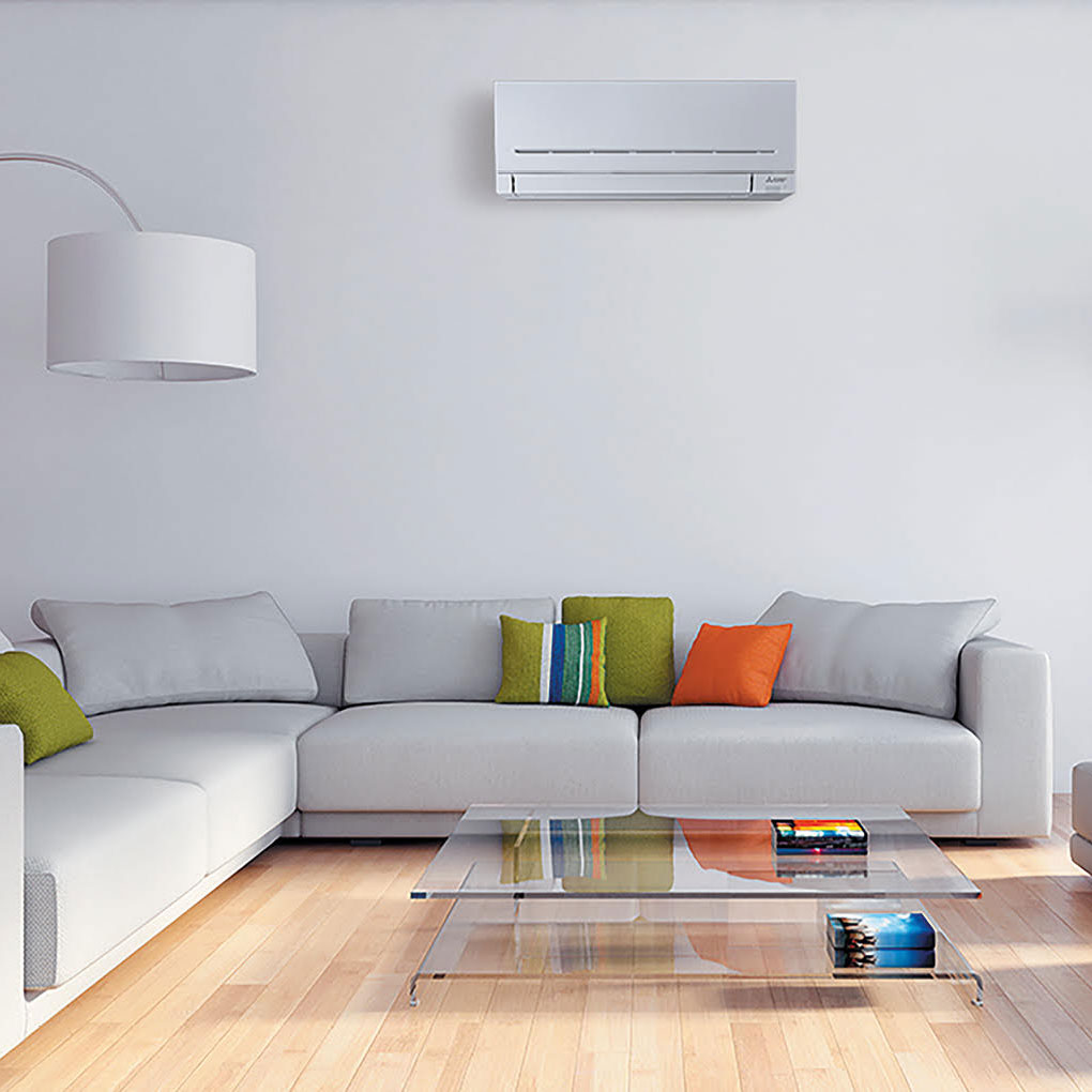 grey living room with air conditioning unit above sofa