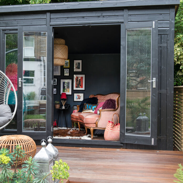 Black garden room with wooden decking