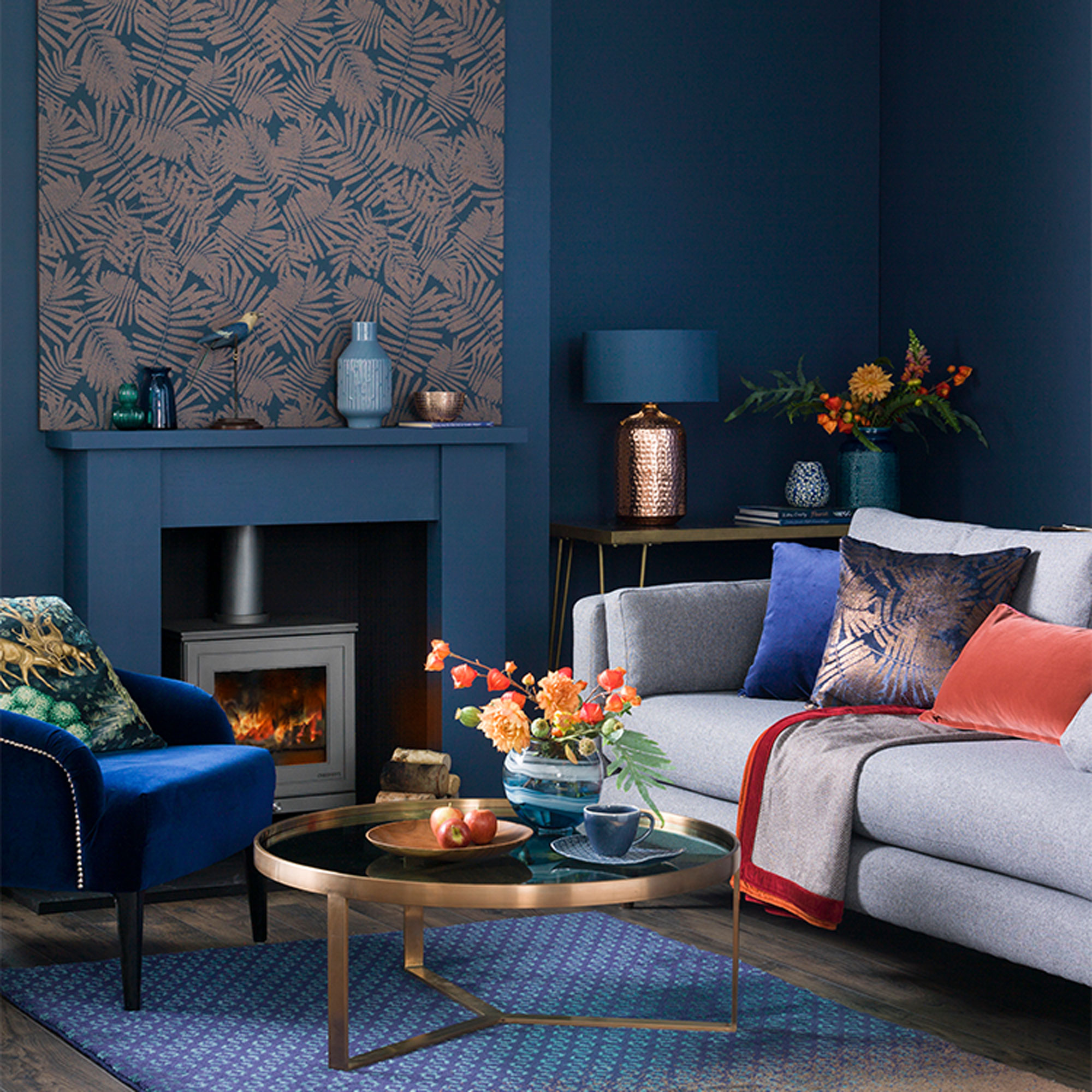 navy blue living room with grey sofa and copper accents