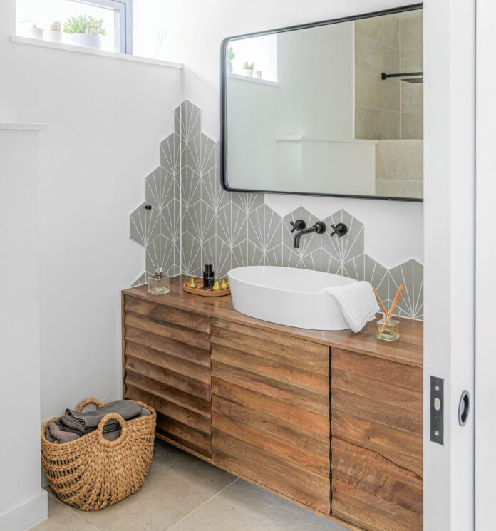 white downstairs cloakroom with wooden sink storage unit