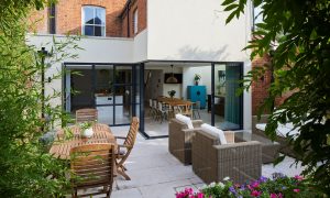 exterior of a Victorian house with a large kitchen diner extension and full width patio glazing