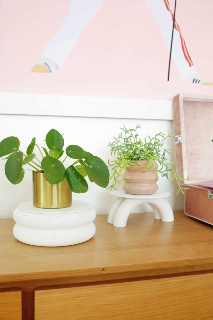 two plants stand made from foam wreaths on a desk