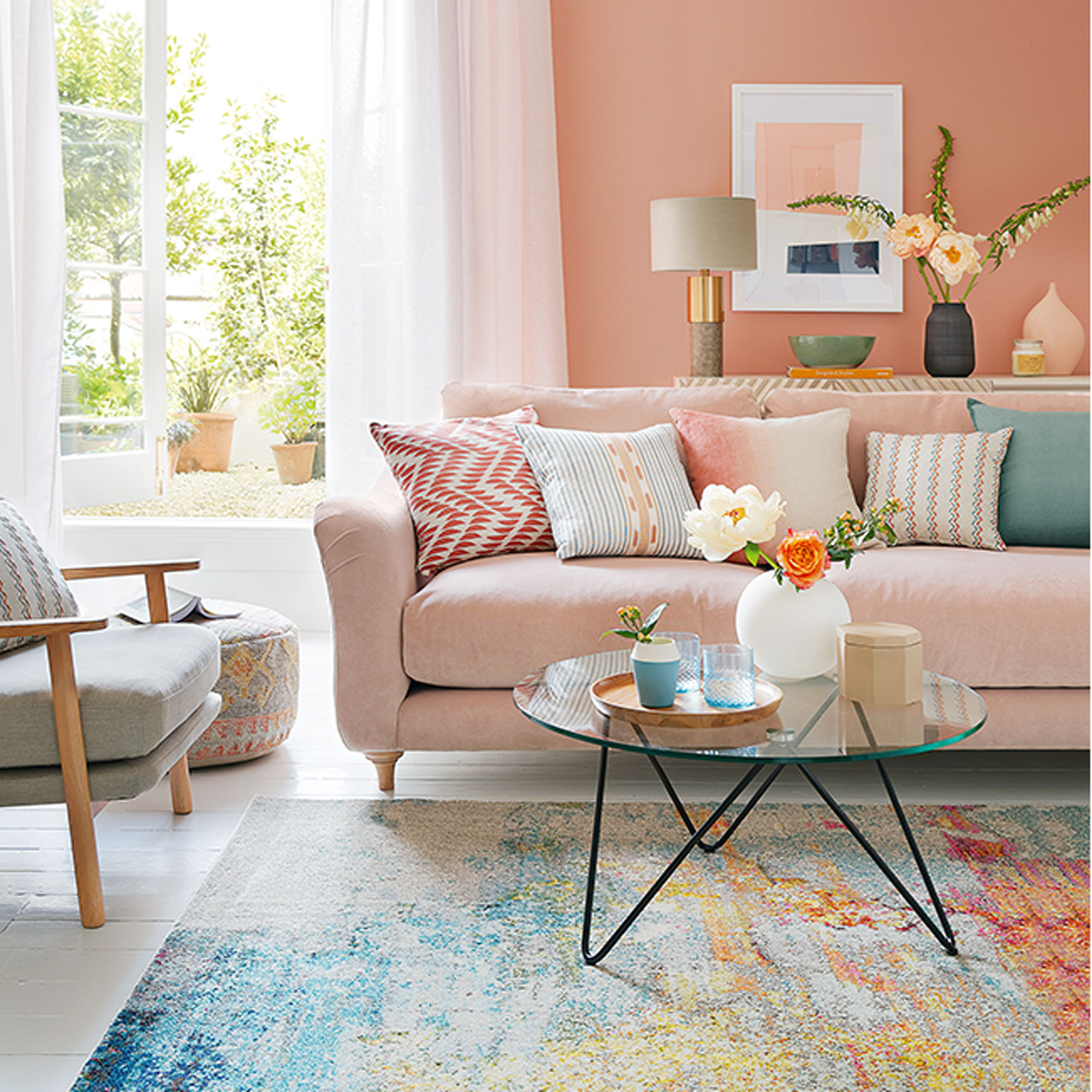coral living room with coral sofa and blue rug