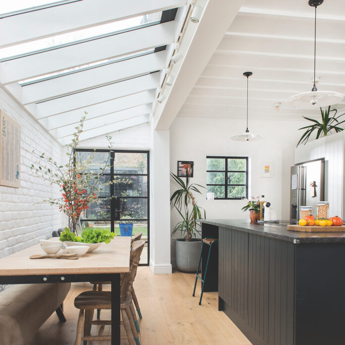 White kitchen extension with black kitchen island