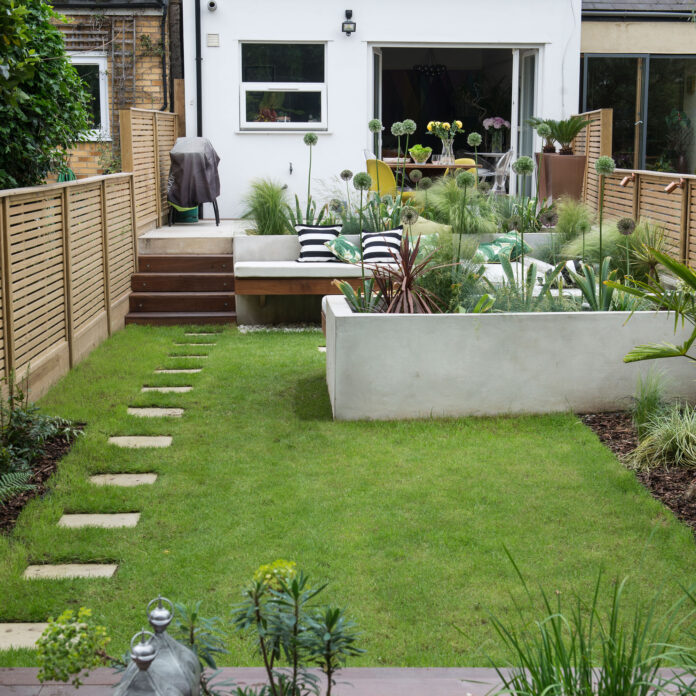 narrow garden with lawn, hard landscaping and stepping stone path